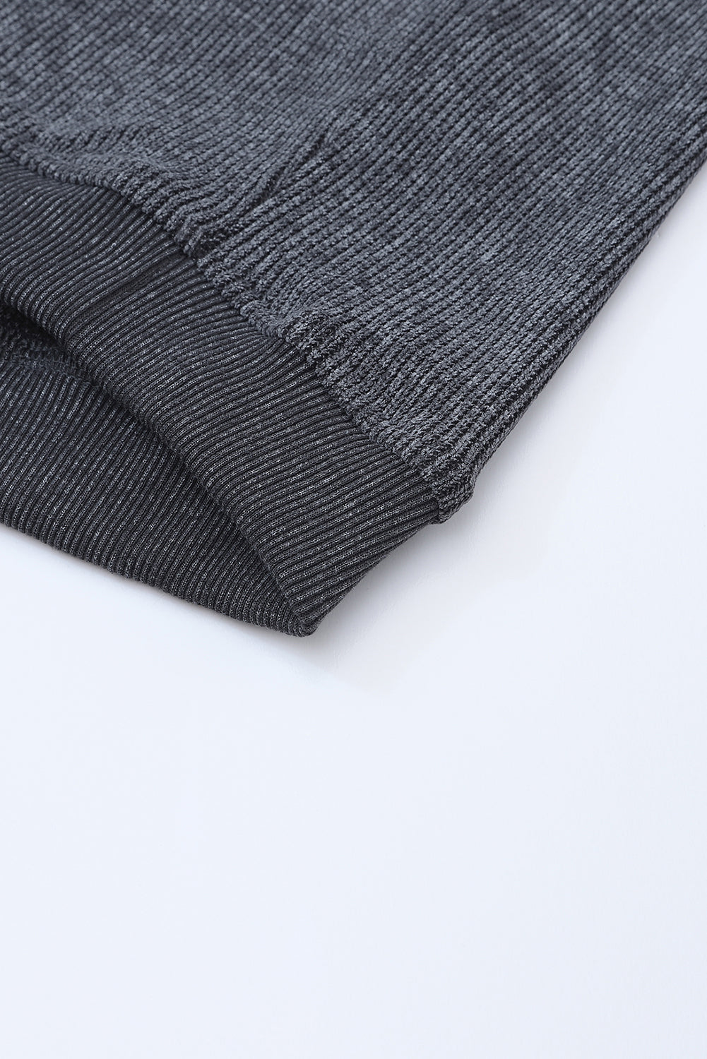 Close-up of a gray textured sweatshirt fabric on a white background