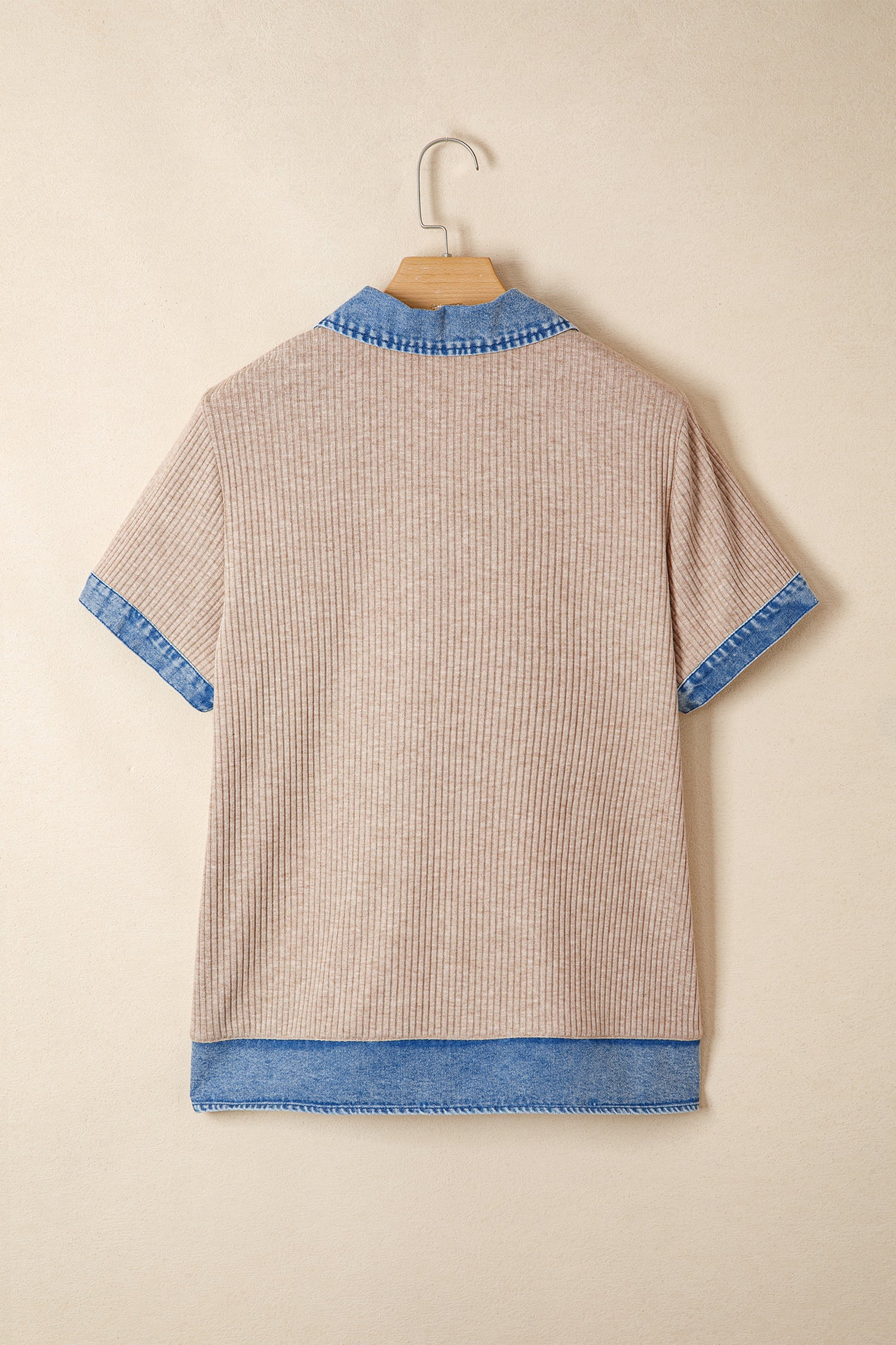 Beige sweater with blue trim on a beige background
