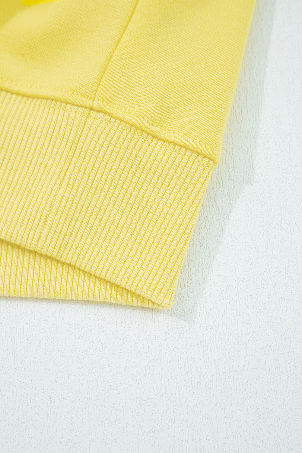 Close-up of a yellow textured fabric on a white background