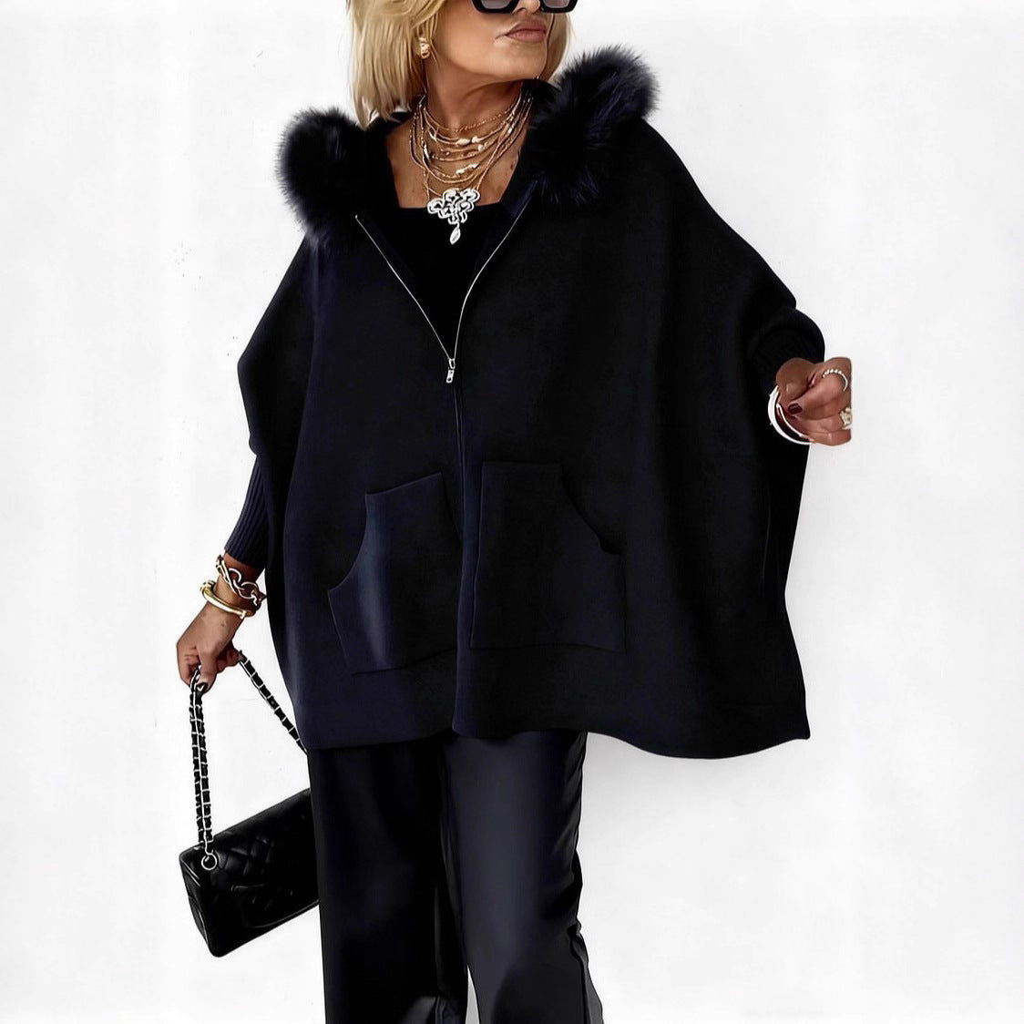 Woman wearing a black coat with fur hood on a white background