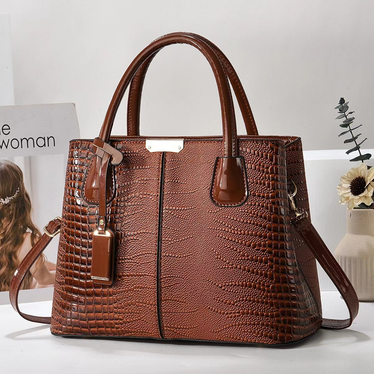 Brown textured handbag on a light background
