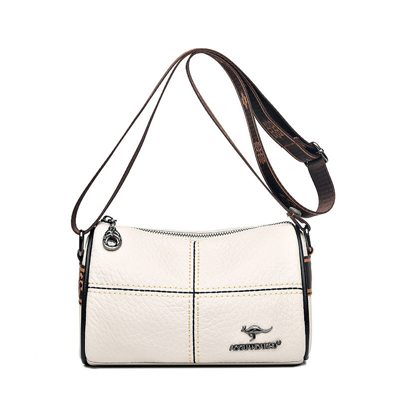 White handbag with a brown strap on a white background