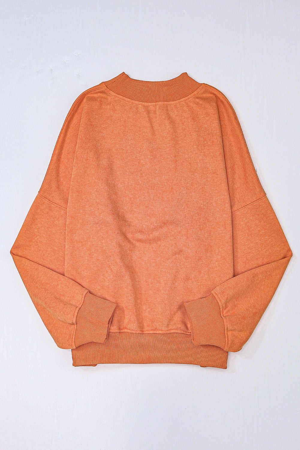 Orange sweatshirt on a light gray background