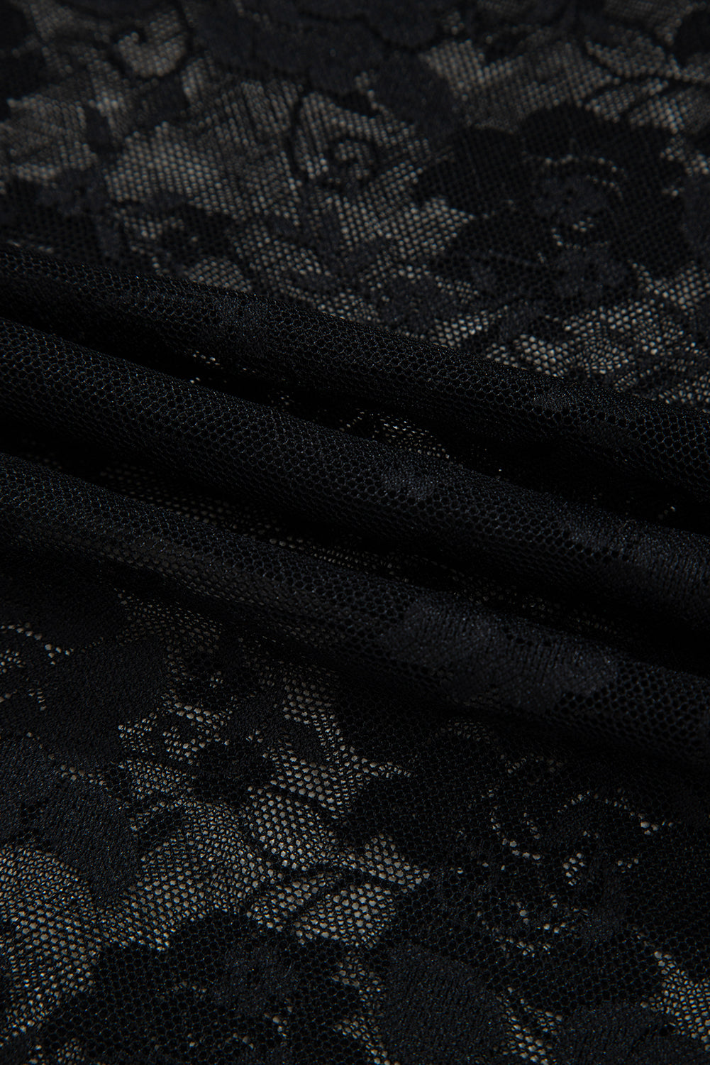 Close-up of black lace fabric with floral patterns