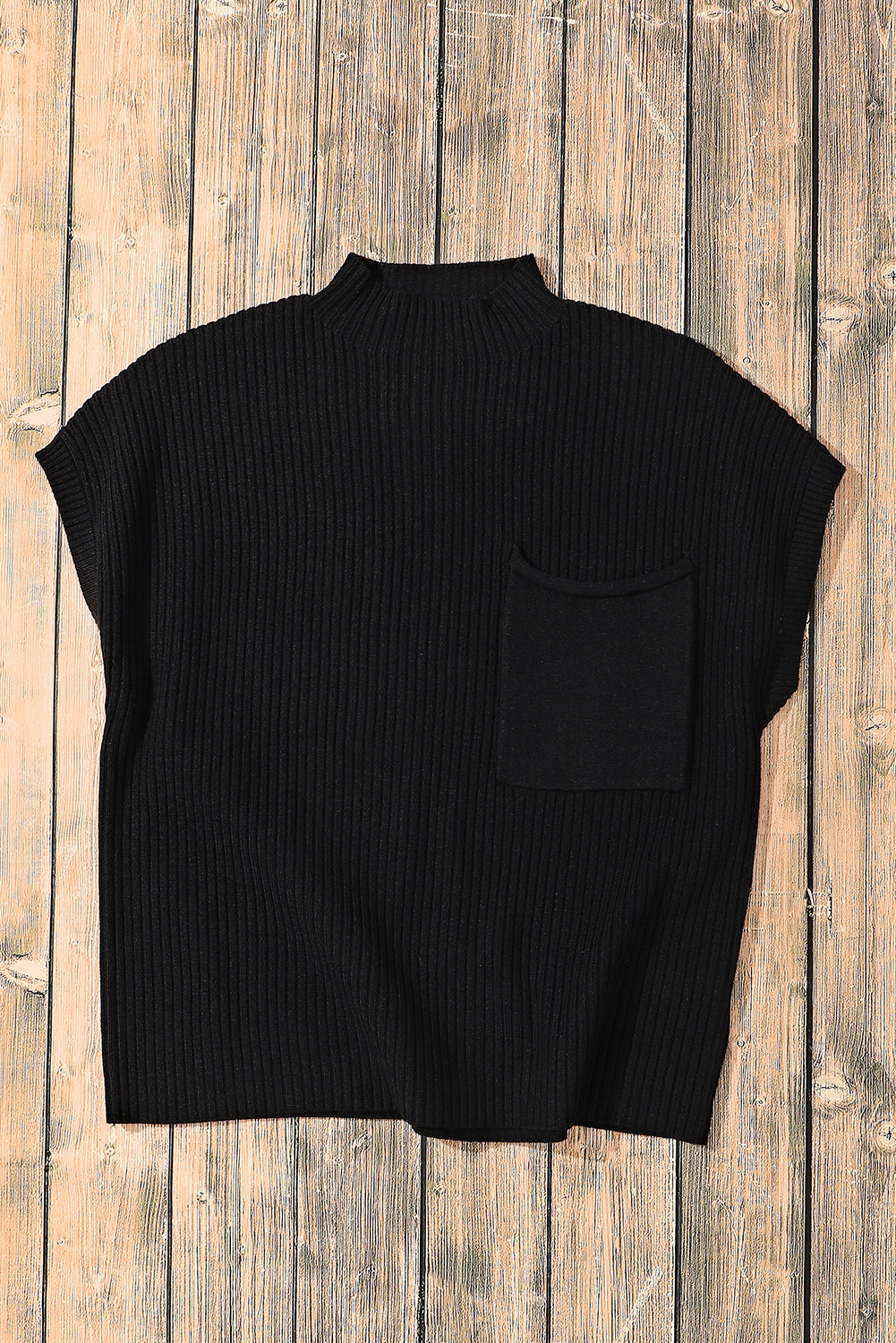 Black sleeveless ribbed sweater vest on a wooden surface