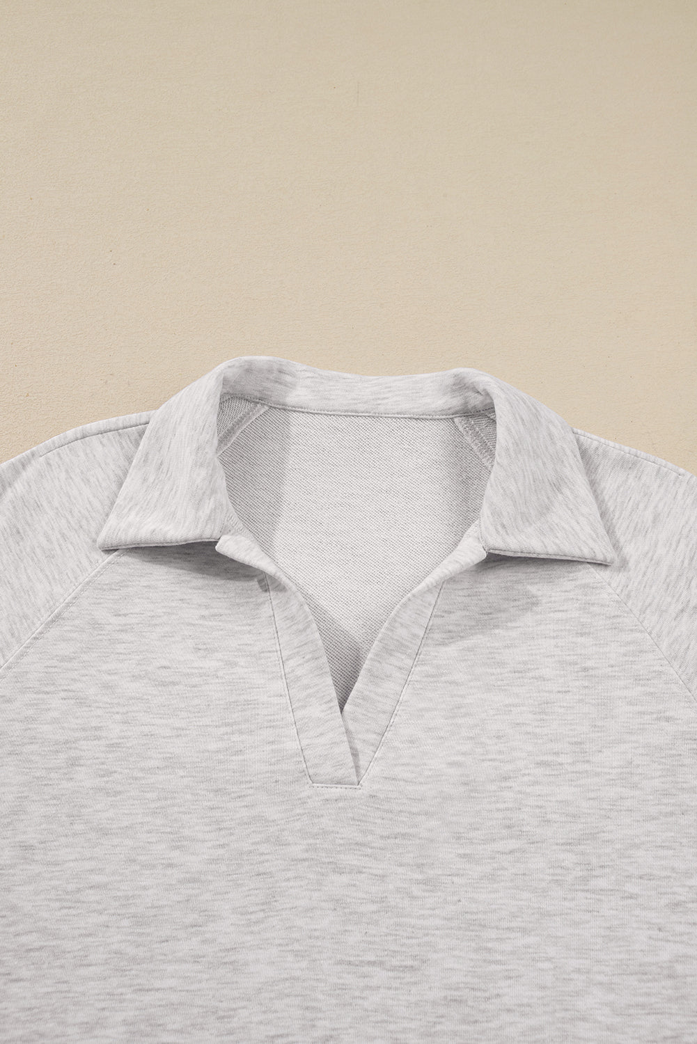 Gray polo shirt on a beige background
