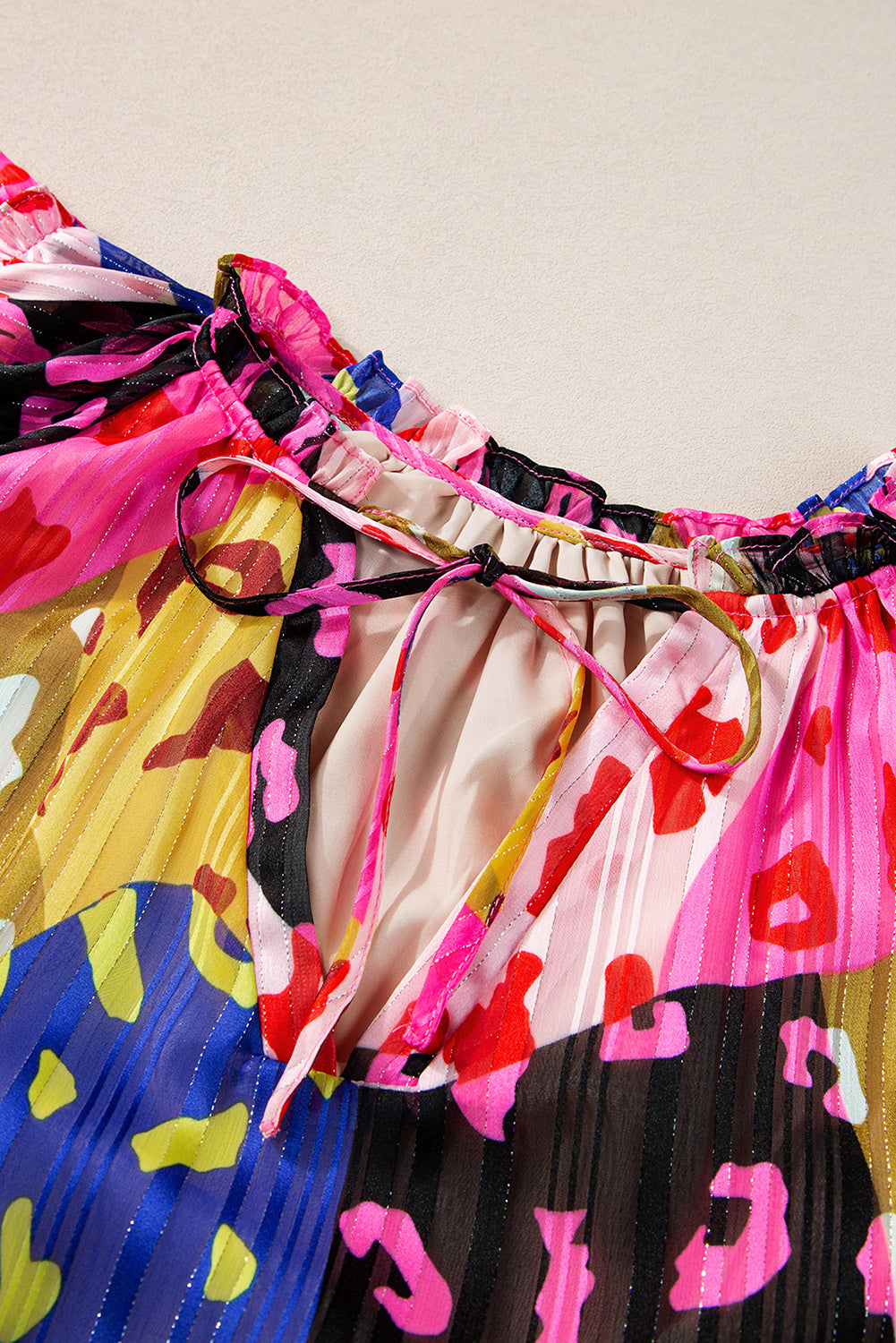 Colorful pleated fabric with abstract patterns on a plain background