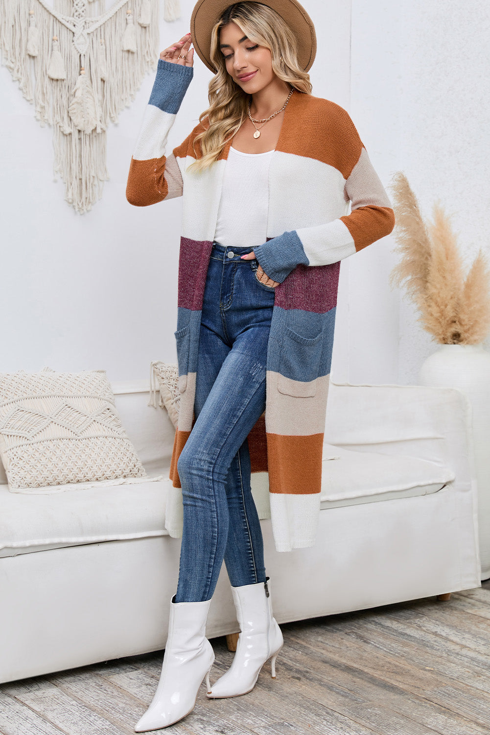 Woman wearing a colorful sweater and jeans in a living room setting