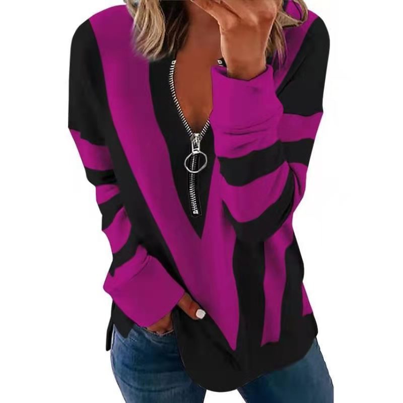 Purple and black zip-up sweatshirt worn by a person on a white background