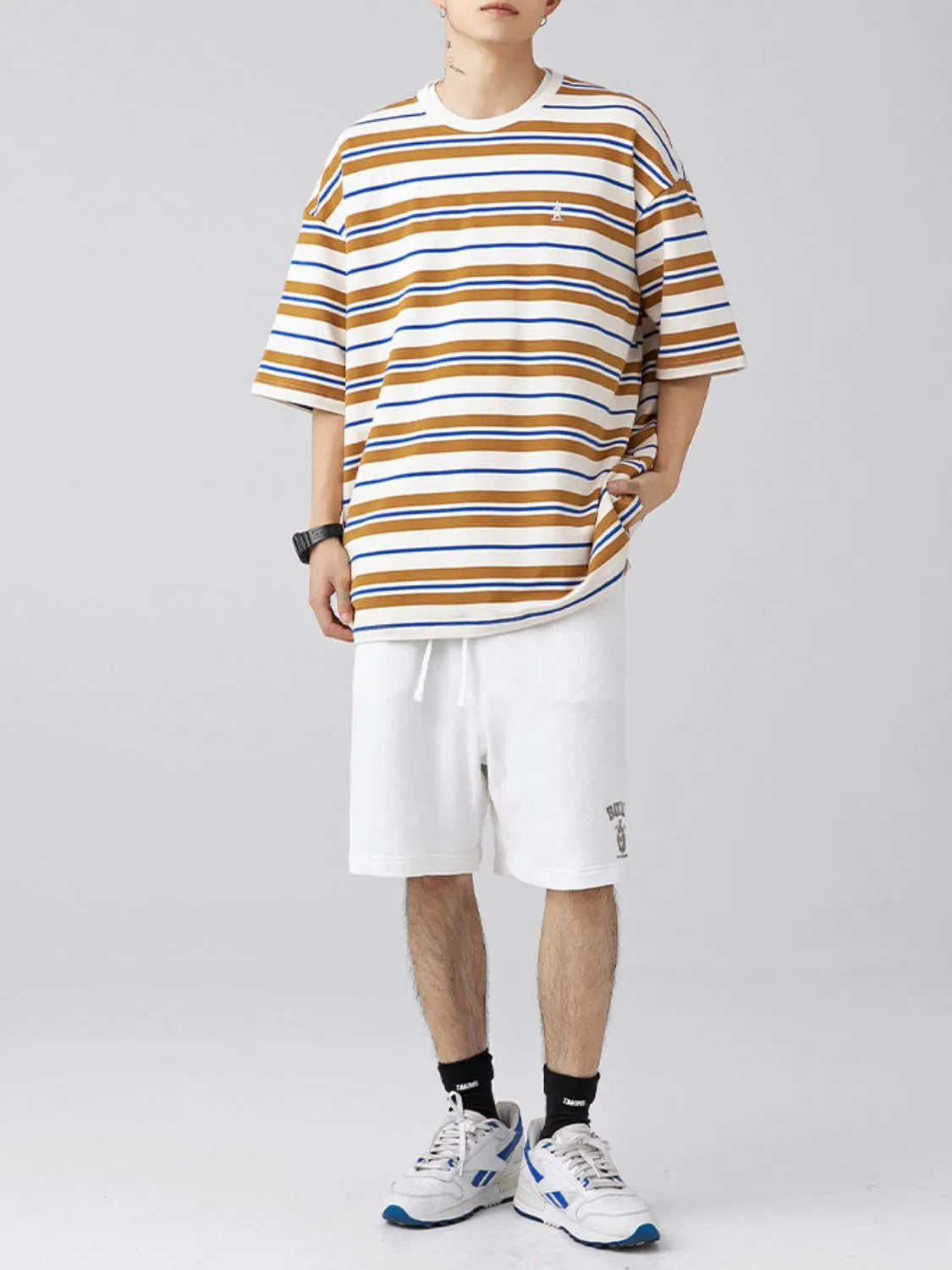 Male model wearing a camel brown urban short sleeve stripe t-shirt front view