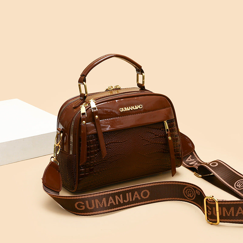 Brown handbag with visible brand name on a beige background