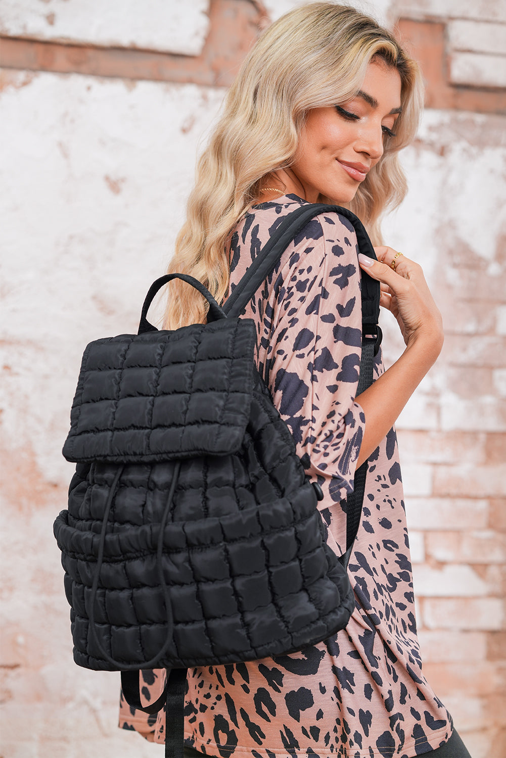 Model wearing a Chic black Quilted Puffer Flap Backpack across the back