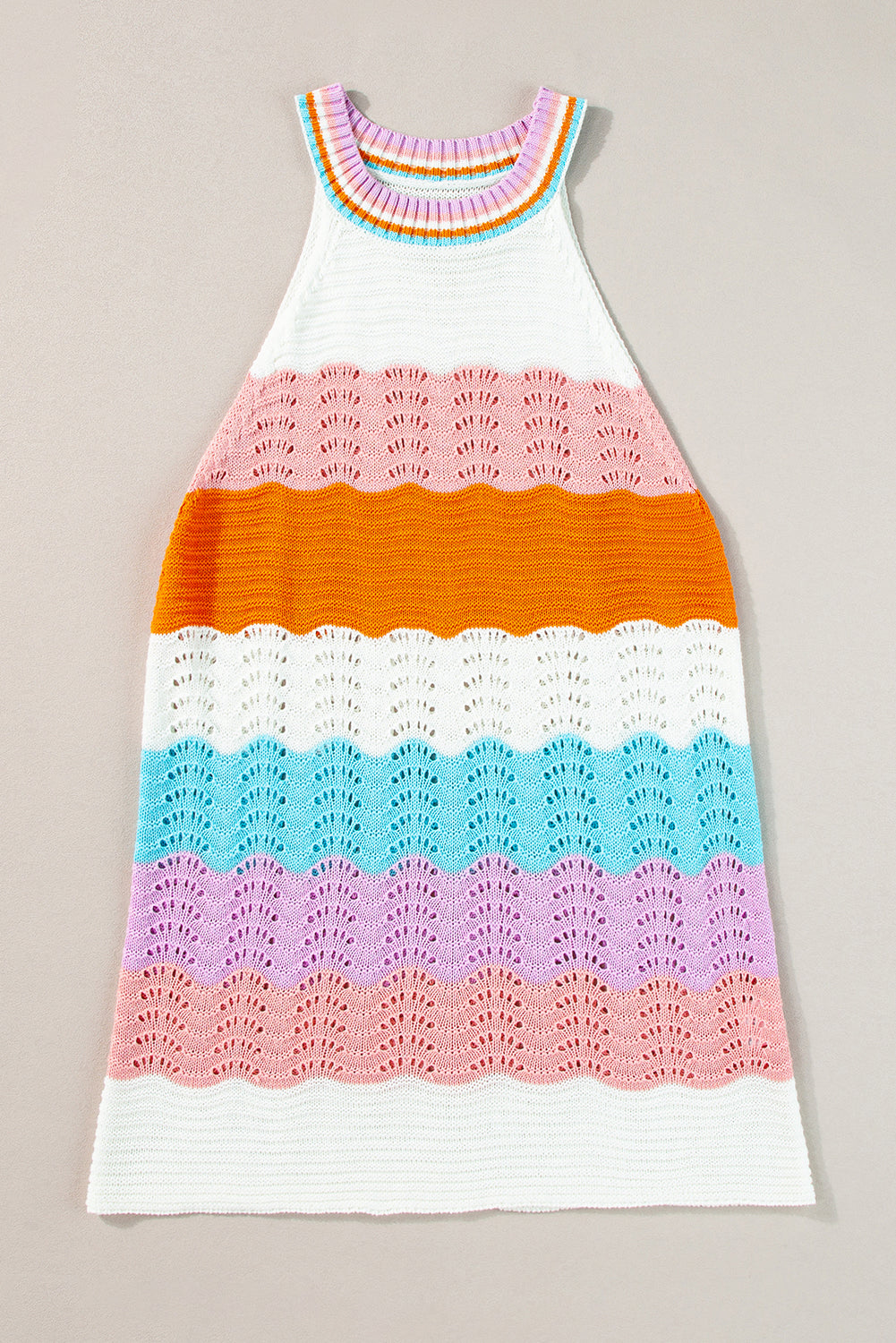 Colorful crocheted dress with a gradient pattern on a beige background