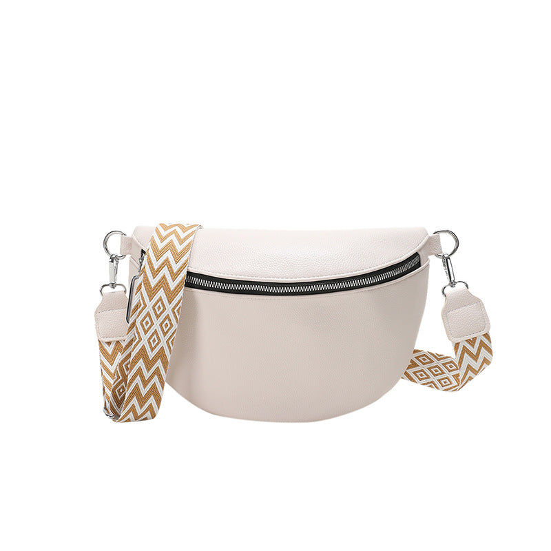 Beige waist bag with gold and white patterned straps on a white background