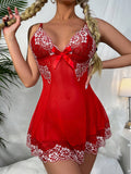 Red lace lingerie set with white accents worn by a model in a bedroom setting.