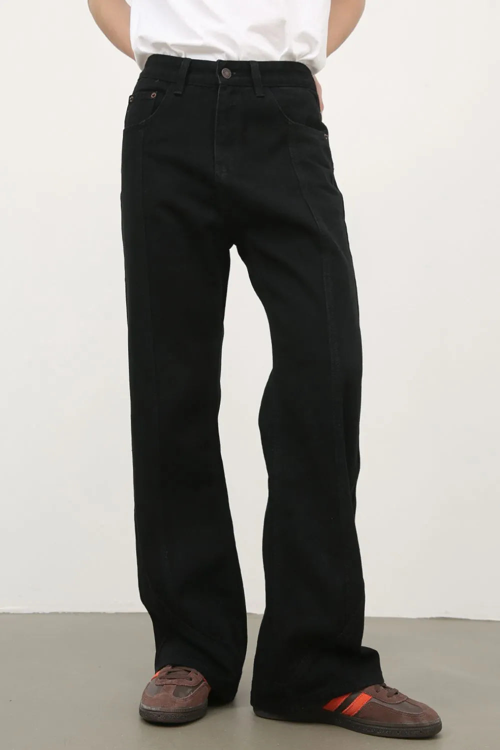 Model wearing a pair of Men's Black Relaxed Slim Fit Jeans