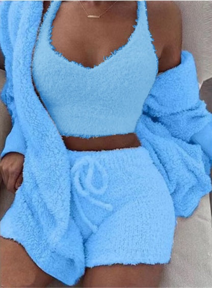 Blue fuzzy two-piece set with matching jacket on a neutral background