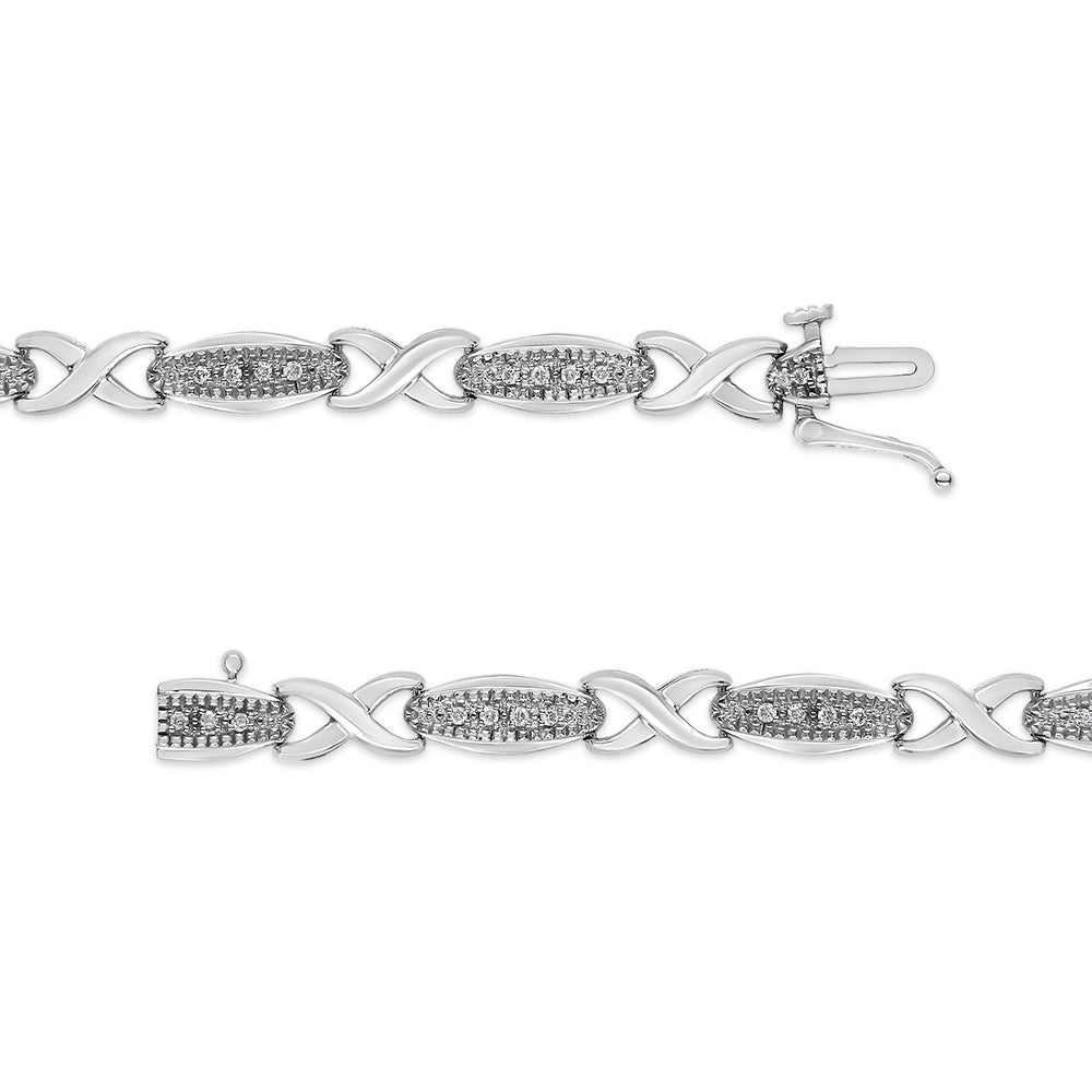 Silver bracelet with diamond accents on a white background