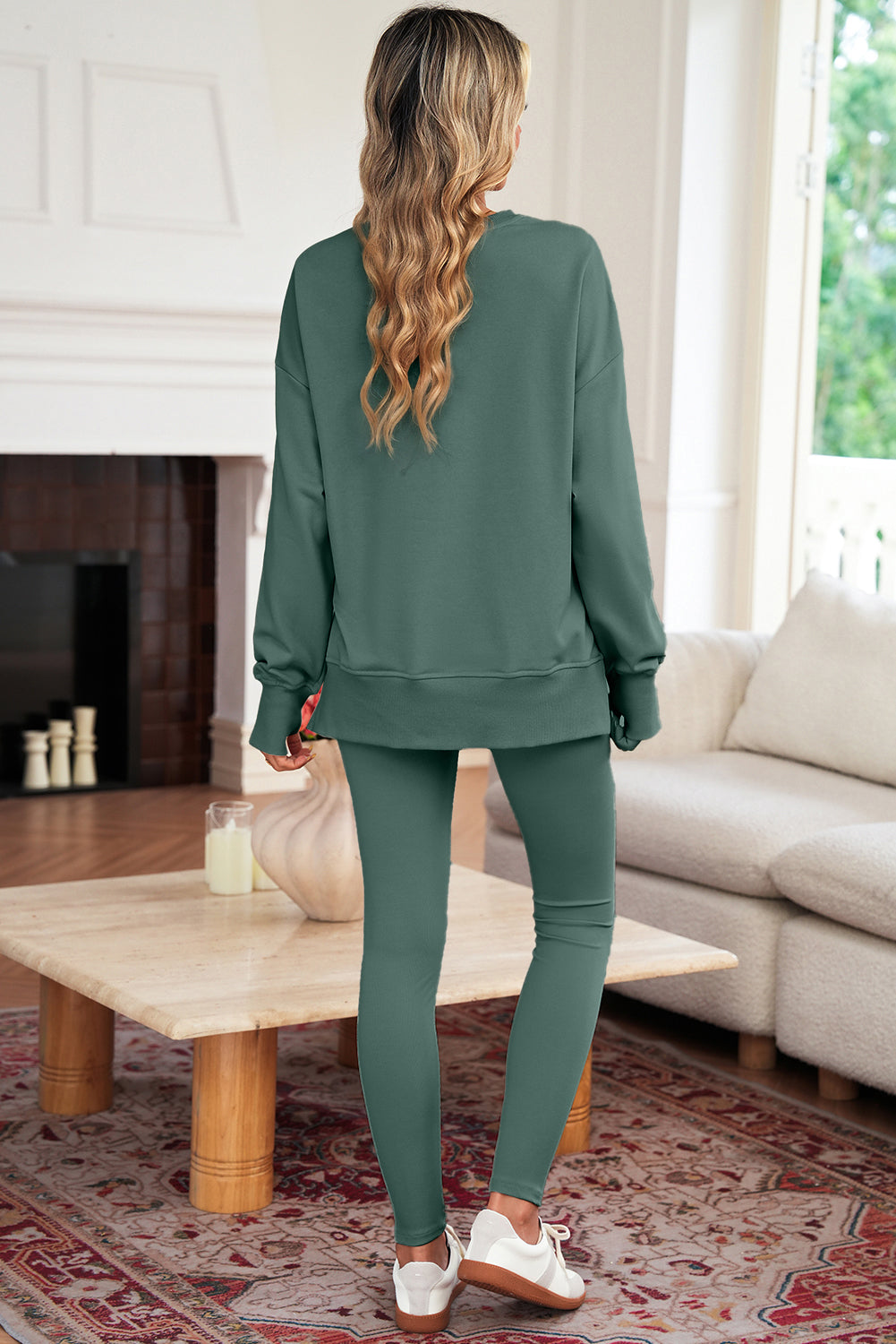 Woman wearing a green outfit in a living room setting