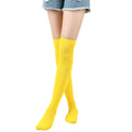 Yellow knee-high socks worn with denim shorts on a white background