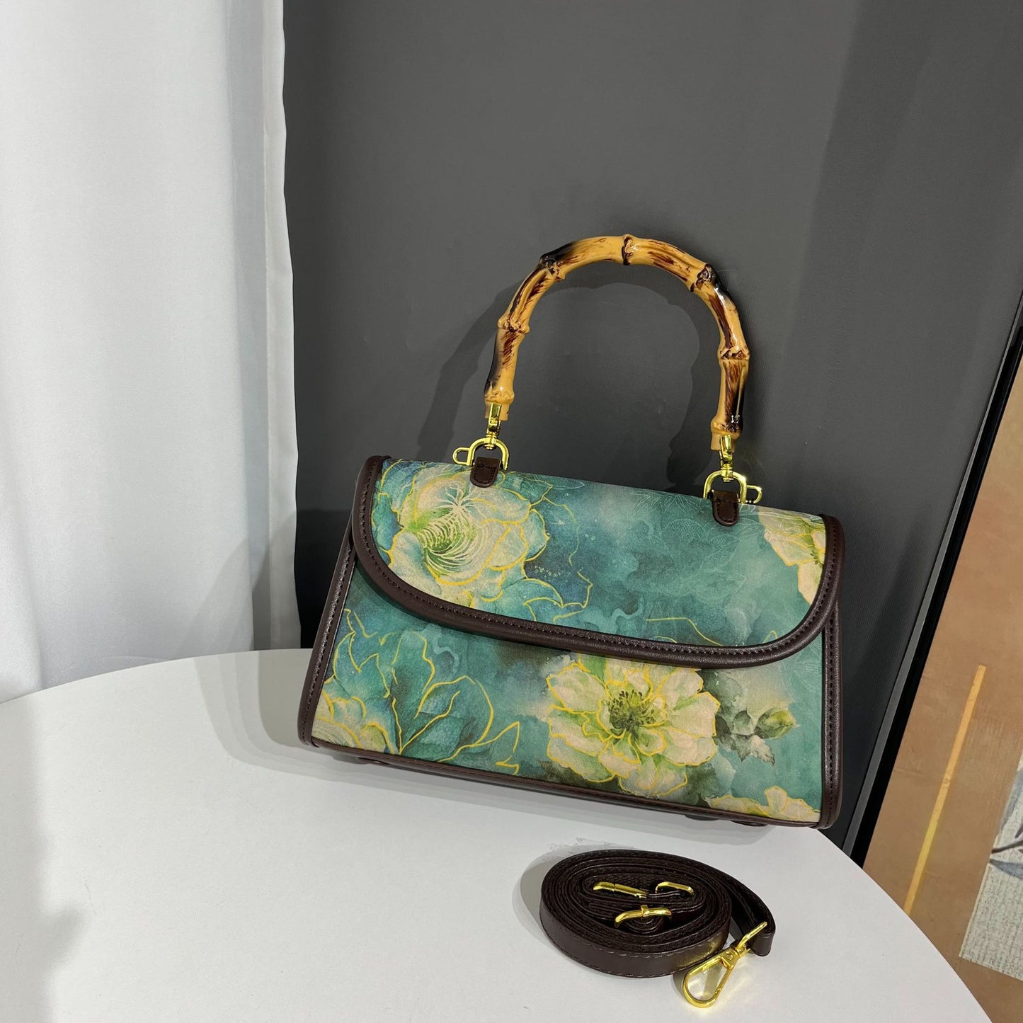 Handbag with floral design on a white surface