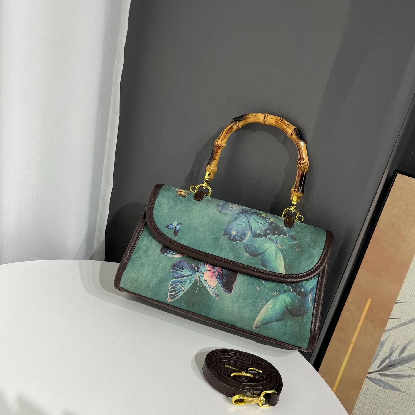 Handbag with butterfly design on a white surface