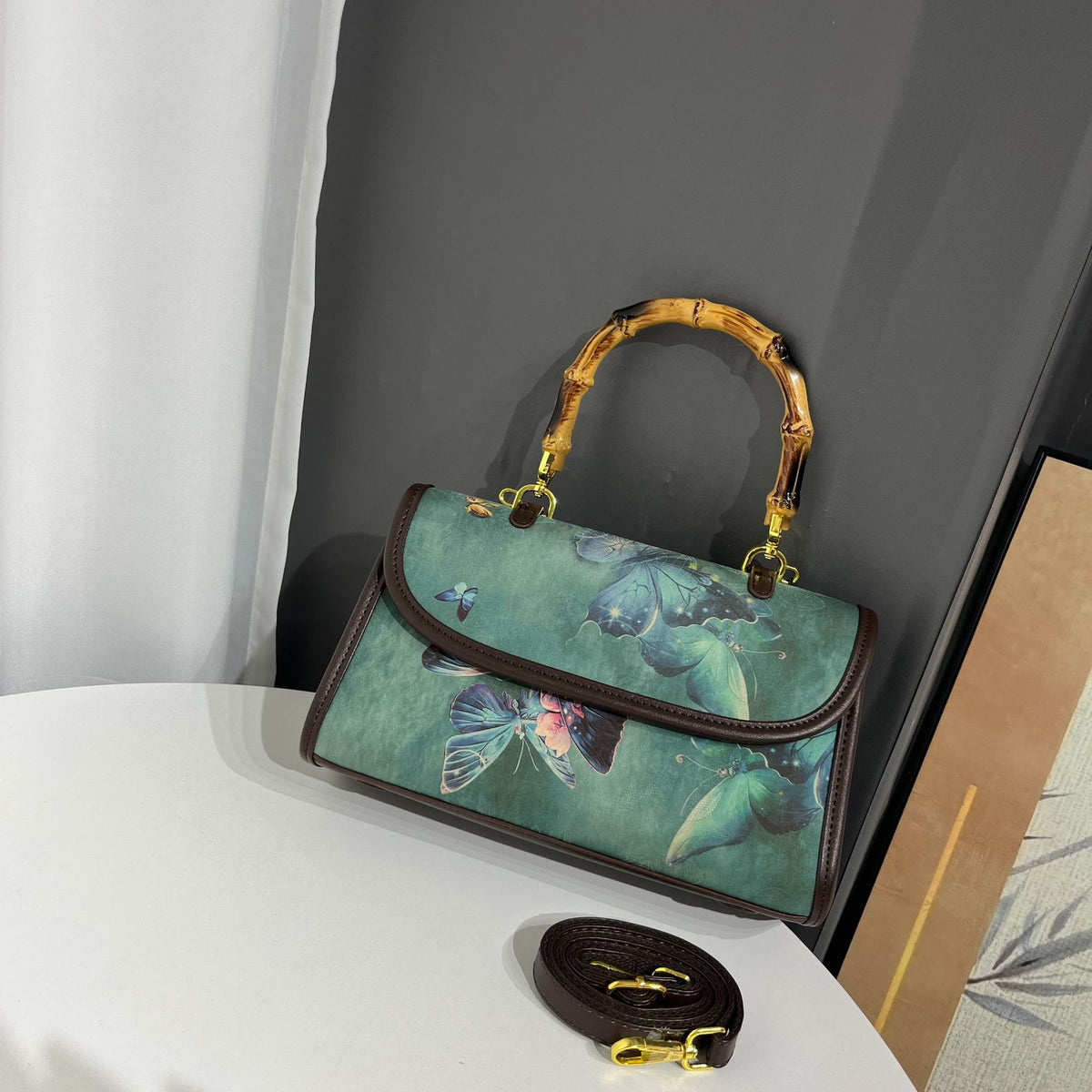Handbag with butterfly design on a white surface