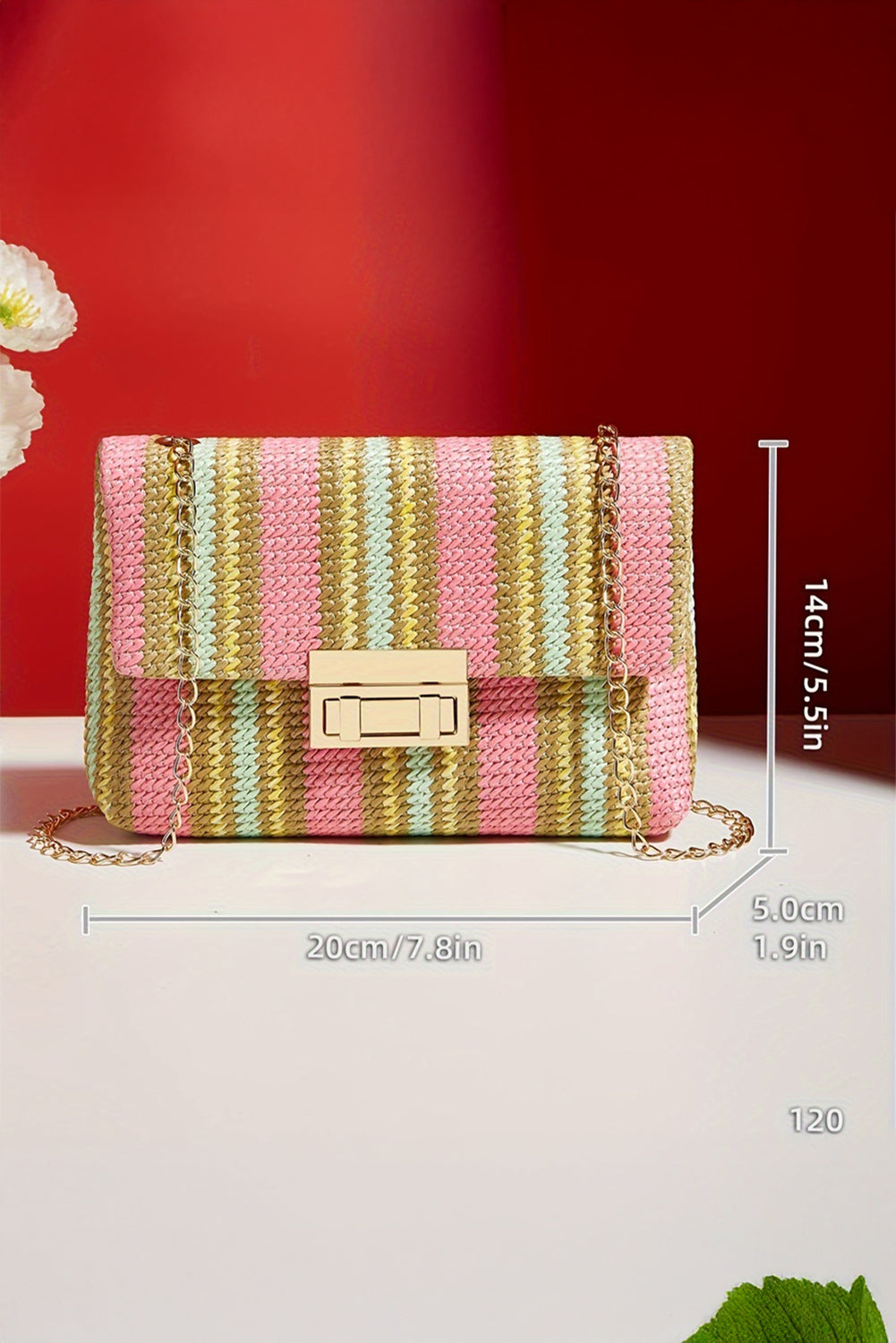 Striped handbag with dimensions on a white surface and red background 5.5inx1.9inx7.8in