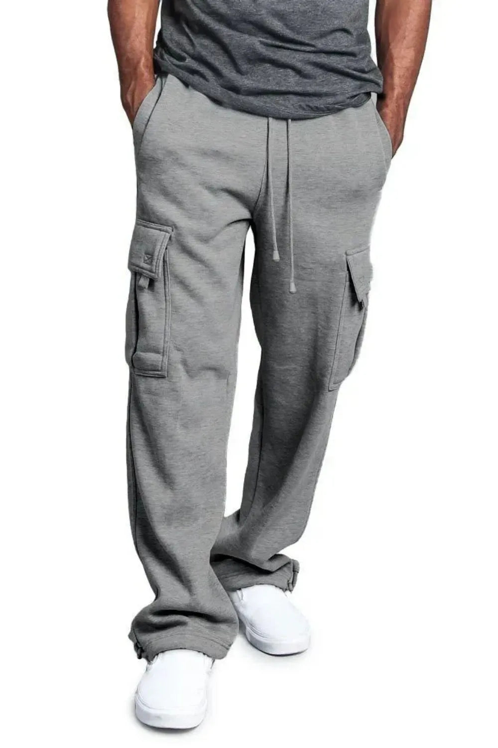 Male model wearing a pair of gray casual draw string cargo joggers pants 