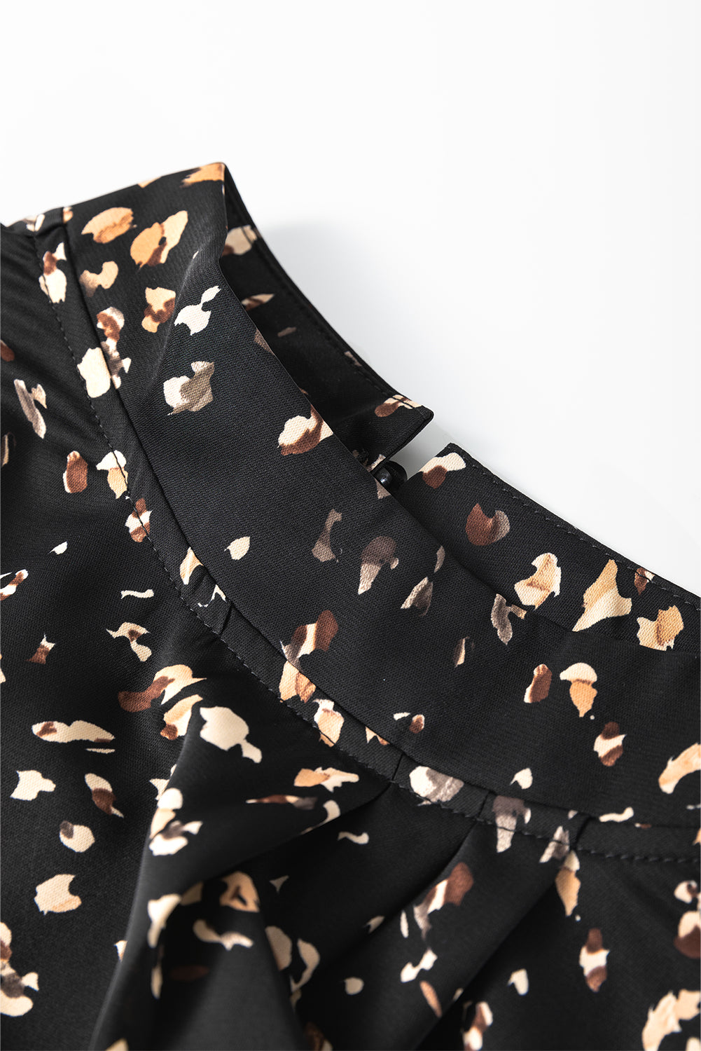 Black dress with animal print pattern on a white background