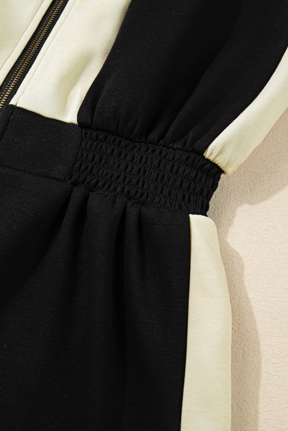 Close-up of a black and white outfit with a textured fabric detail.
