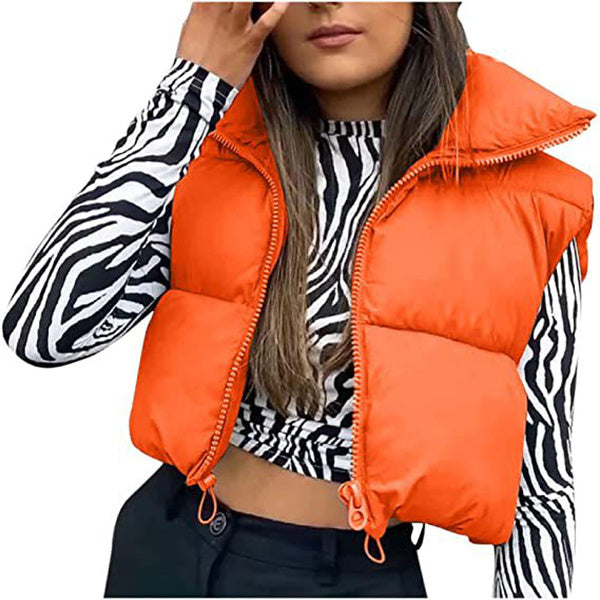 Person wearing an orange puffer vest over a zebra print shirt on a white background