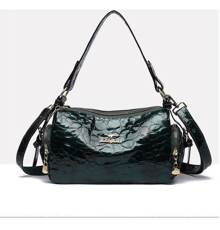 Green textured handbag with gold accents on a white background