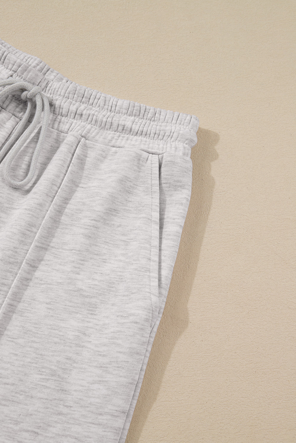 Gray sweatpants on a beige background