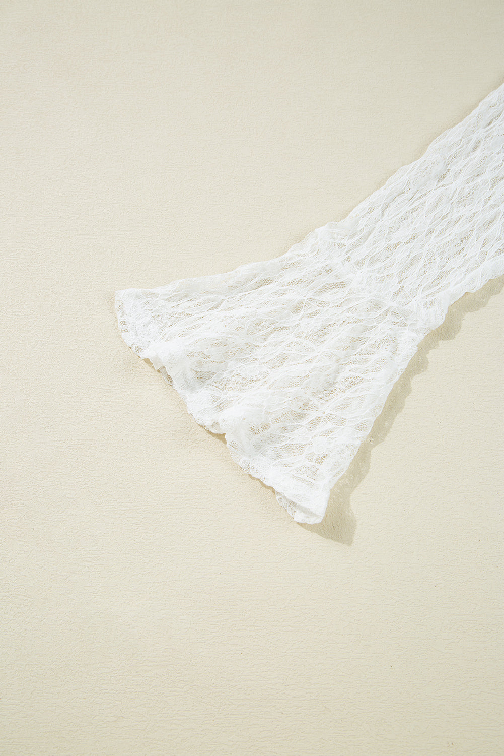 White lace garment on a beige background