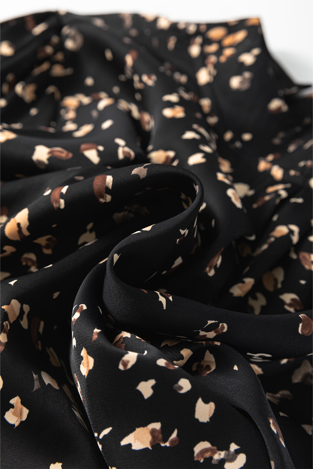 Black fabric with gold and white floral pattern