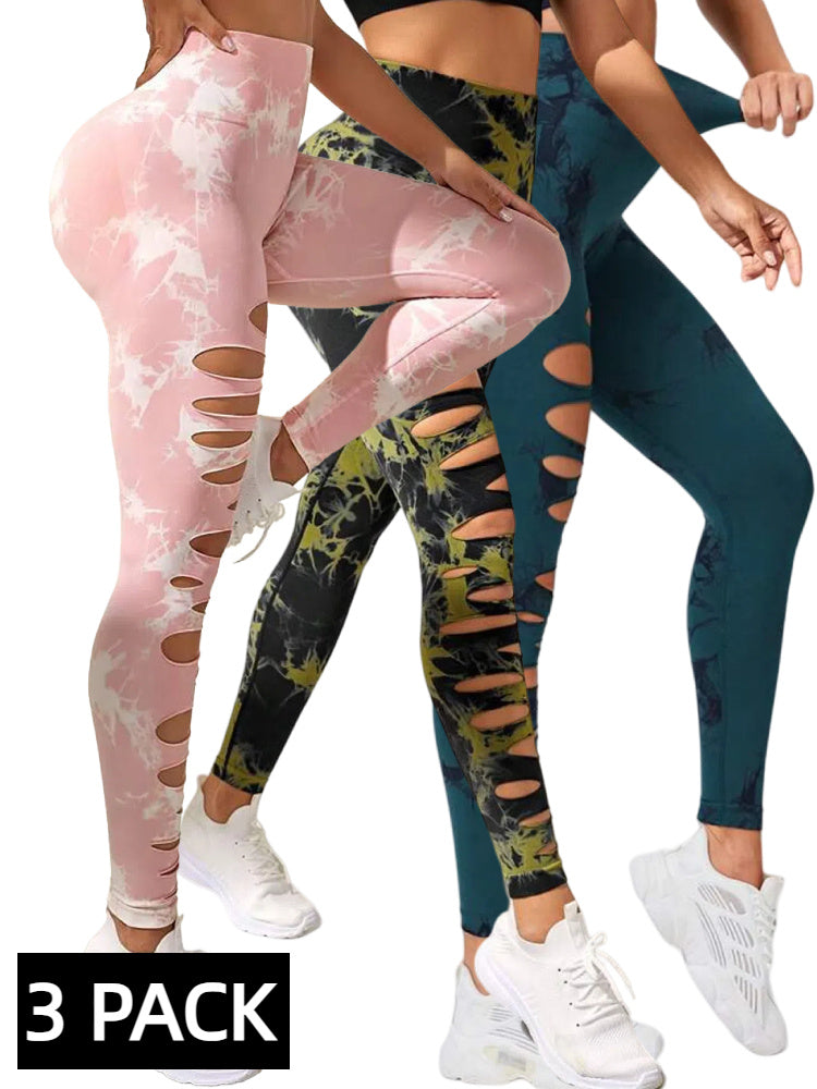 Three pairs of colorful leggings with cut-out designs on a white background.
