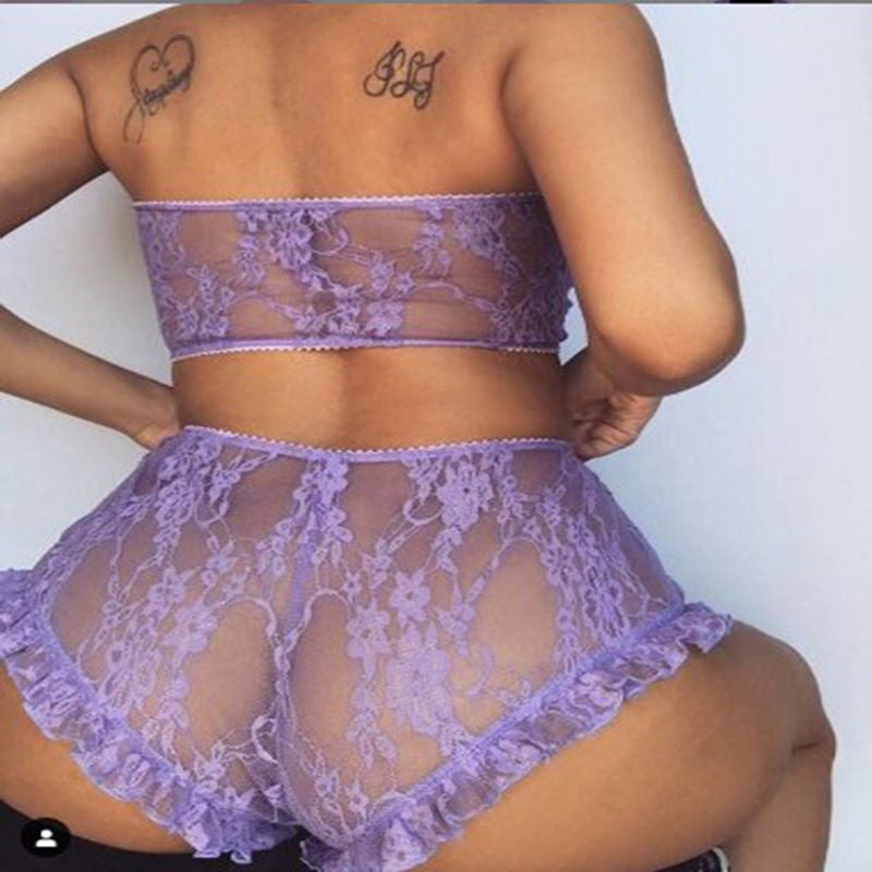 Person wearing a purple lace lingerie set on a plain background