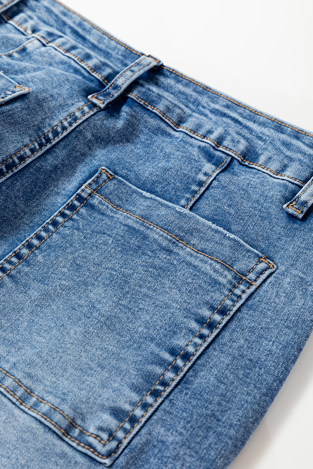 Close-up of blue denim jeans on a white background