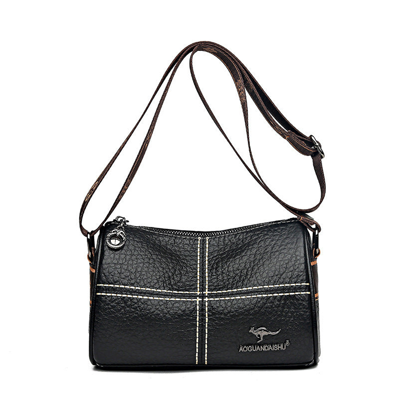 Black leather handbag with a visible brand logo on a white background