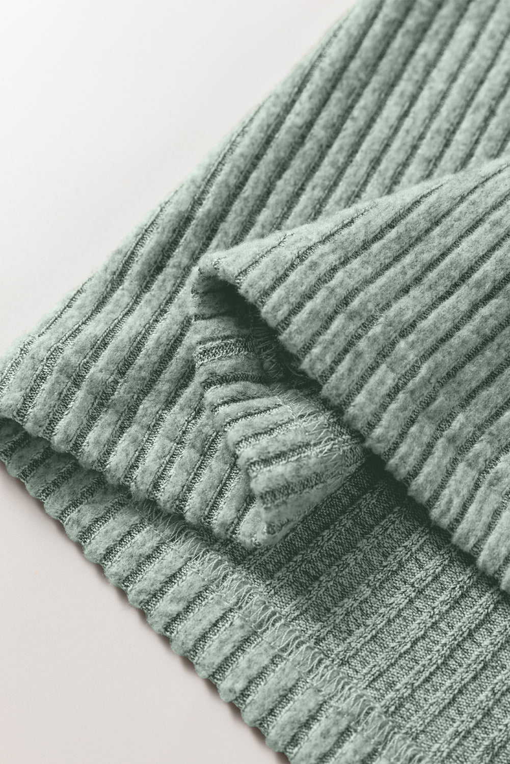 Close-up of a textured green fabric on a light background