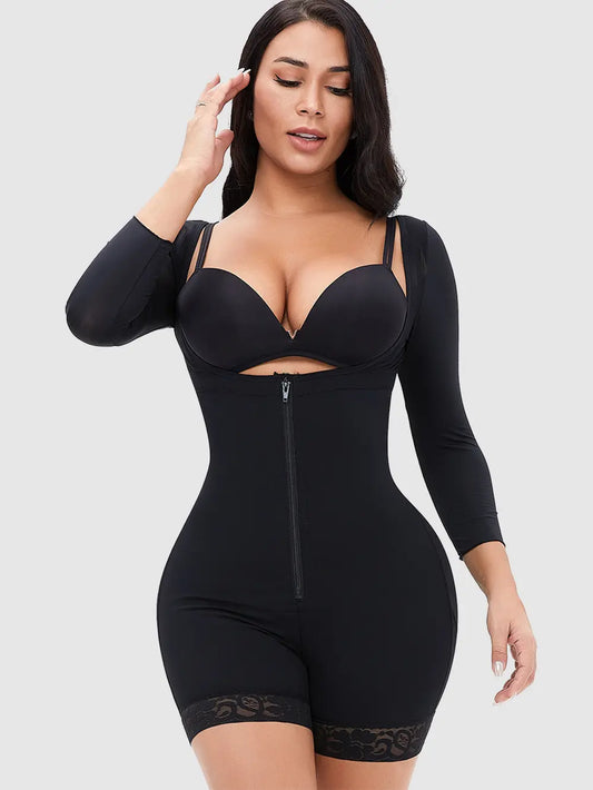Woman wearing a black shapewear bodysuit on a plain background