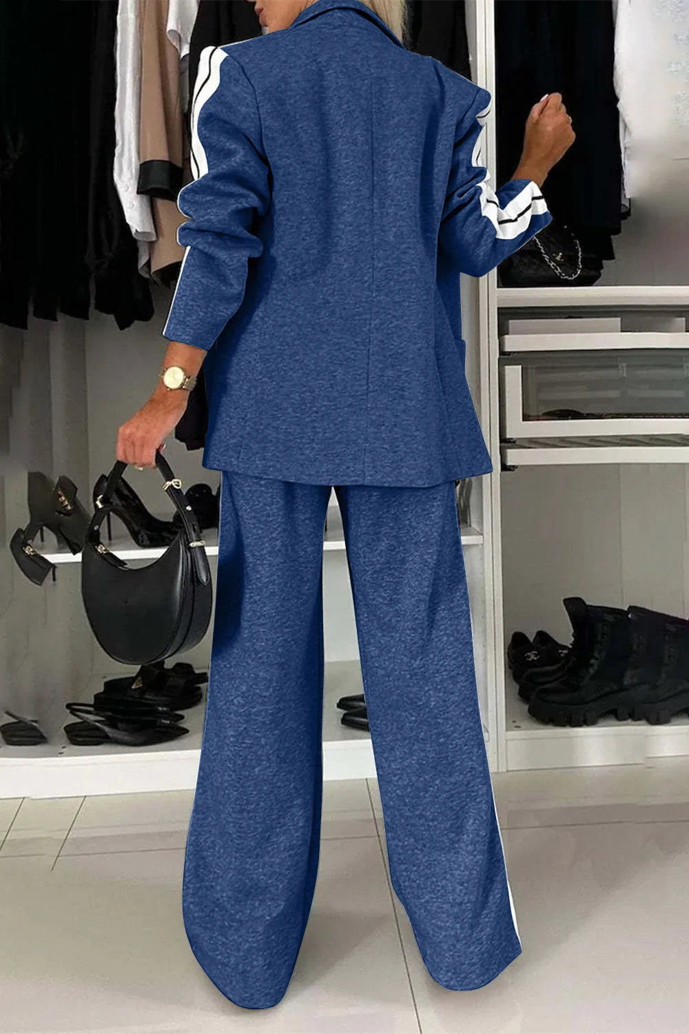 Person wearing a blue suit in a clothing store.