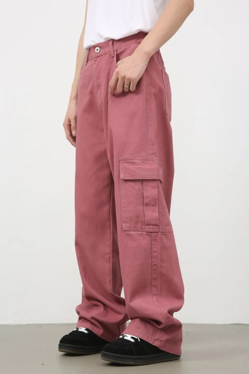 Male model wearing dusty pink Mid Rise Jeans with Cargo Pockets side view