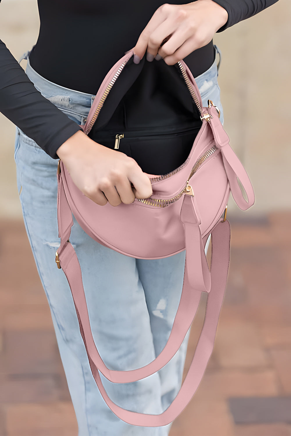 Model showing the opening of a Women's pink Chic & Comfy Wide Strap Crossbody bag 