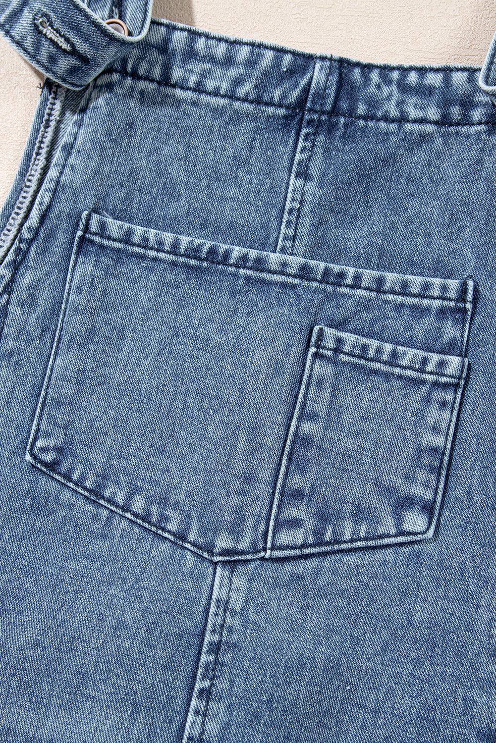 Close-up of blue denim jeans with a pocket detail