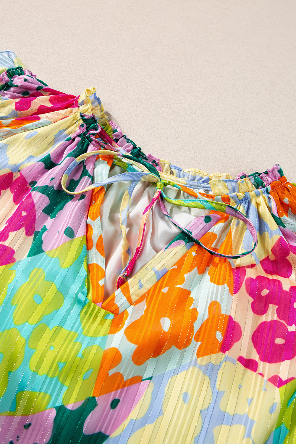 Colorful floral-patterned dress with a beige background