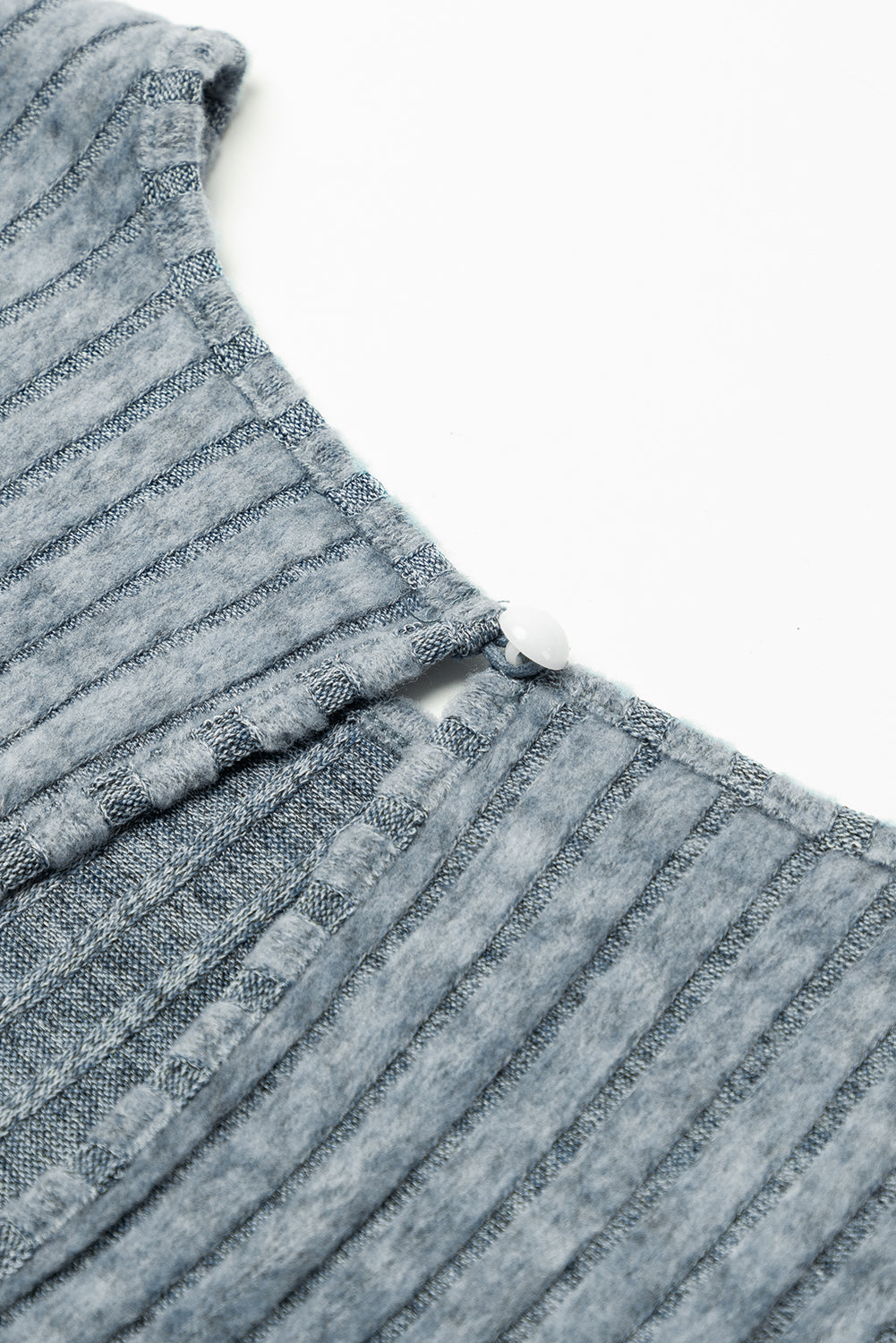 Close-up of a textured blue fabric with a white background