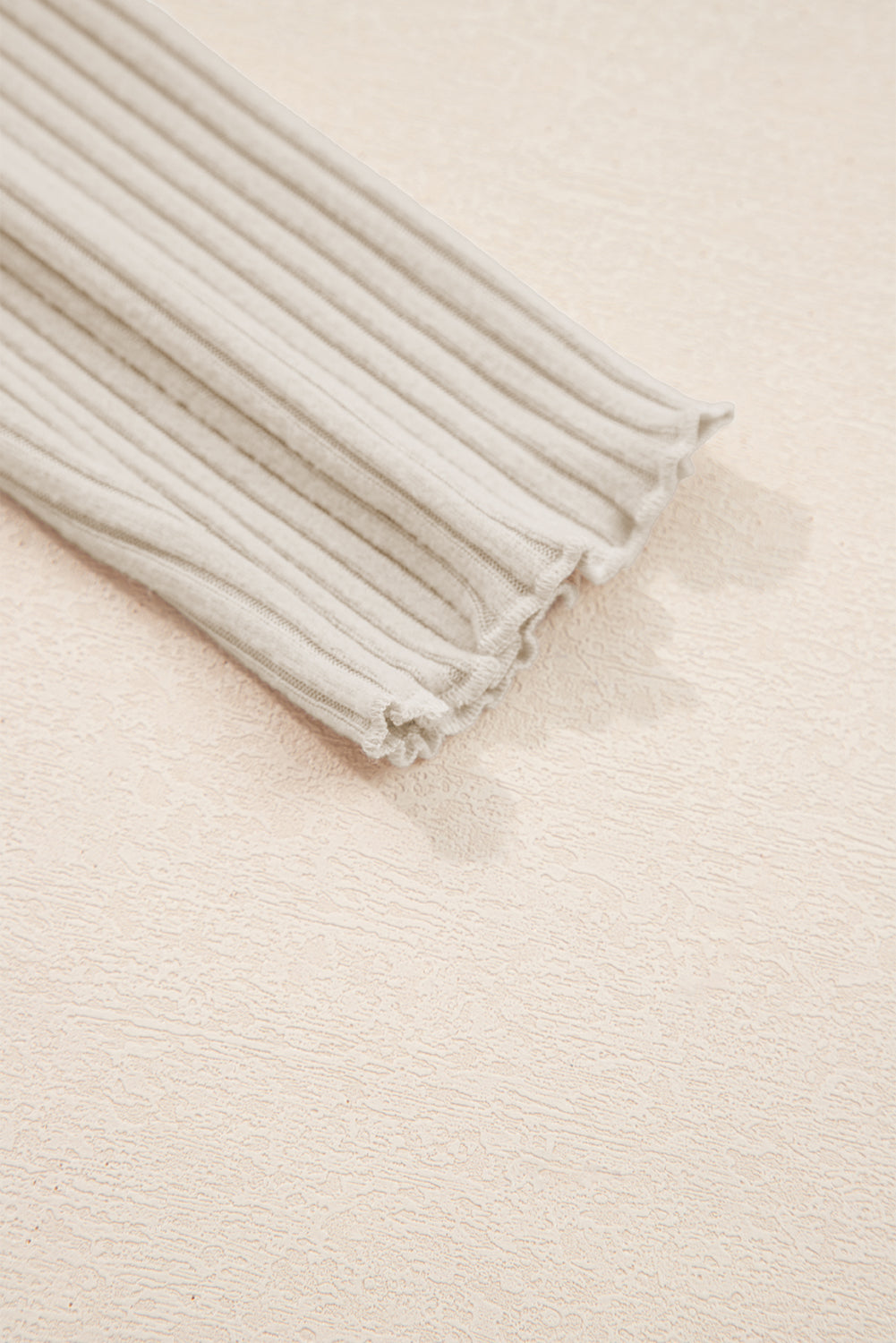 Folded beige fabric on a matching background