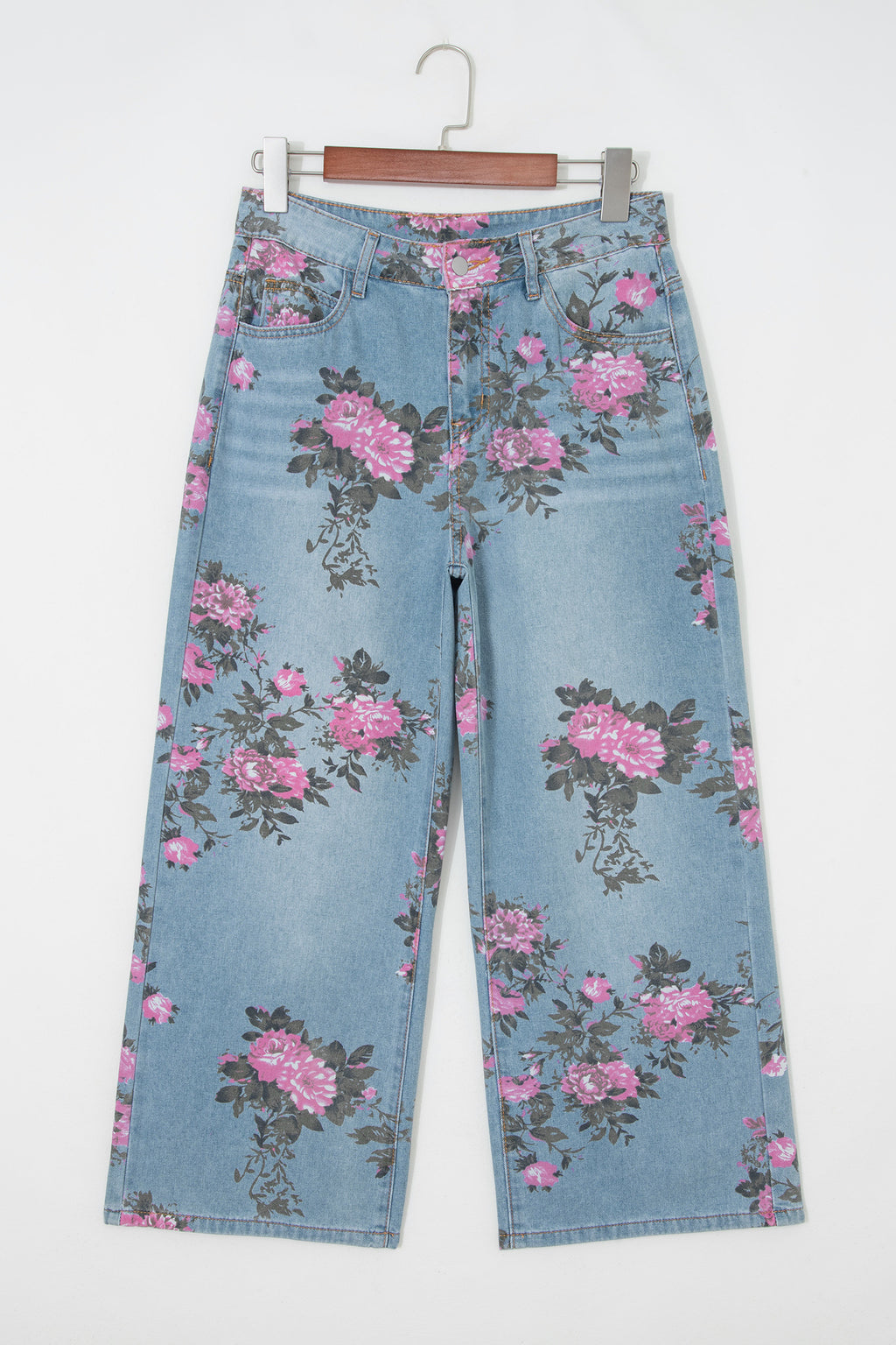 Floral-patterned jeans on a hanger against a white background front view